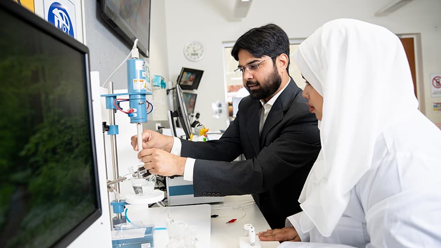 Dr Azhar with PhD student Sadia inside engineering lab