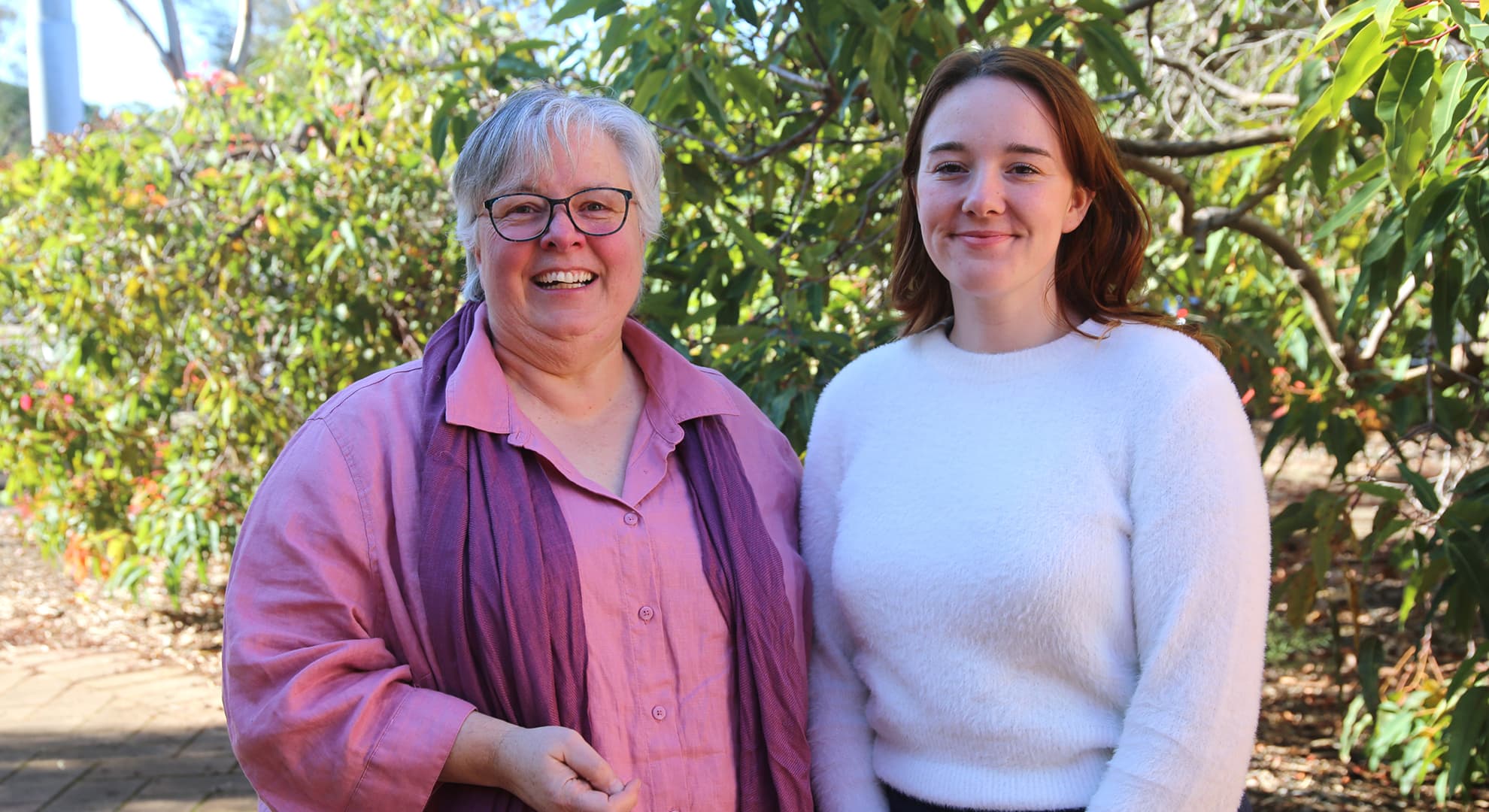 Sian Bennett and Athena Lee stand next to each other outside.