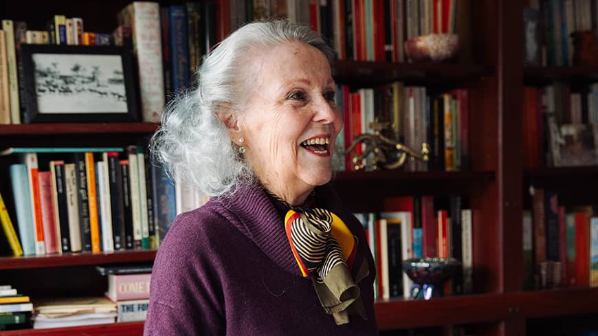 Paula Huston laughing in the library