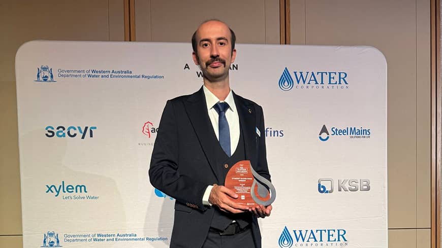 Man standing with award