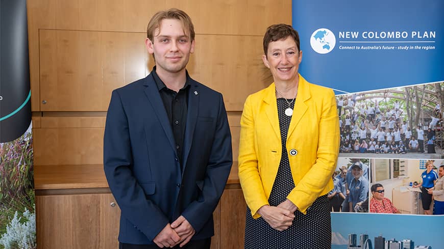 A young man and a woman standing and posing for a photo