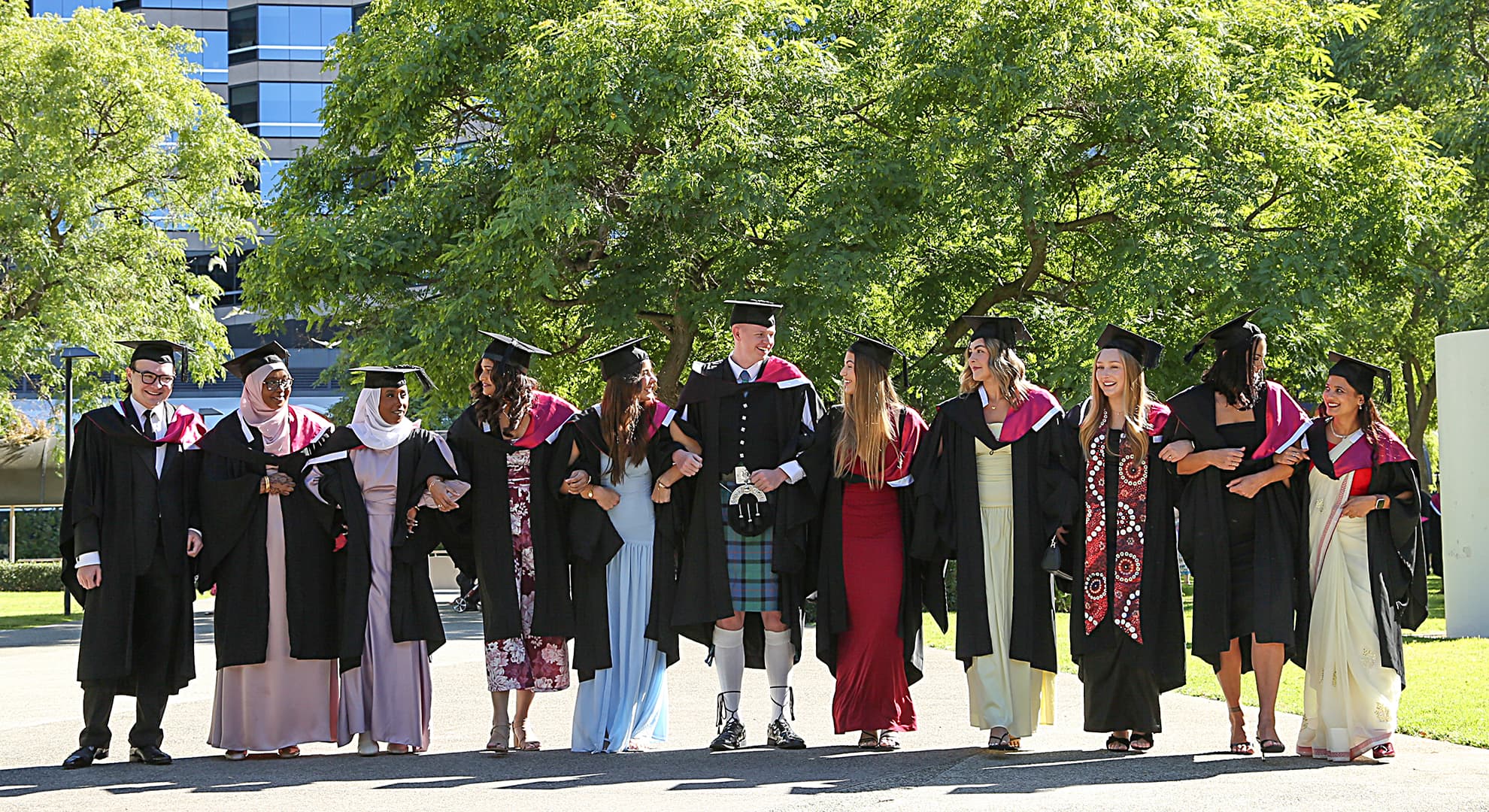 A group of people standing in a line in graduation gowns