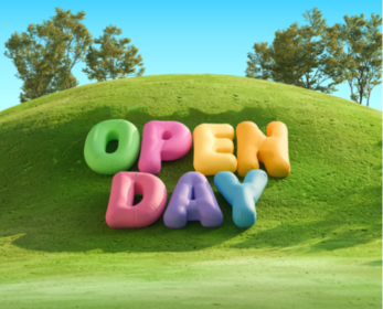 Colourful 3D letters spelling “Open Day” on a grassy hill under a blue sky with trees in the background.