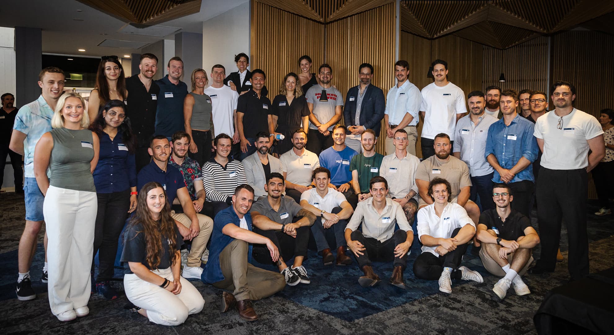 A group photo of students, alumni and strength and conditioning industry professionals at the celebratory event.