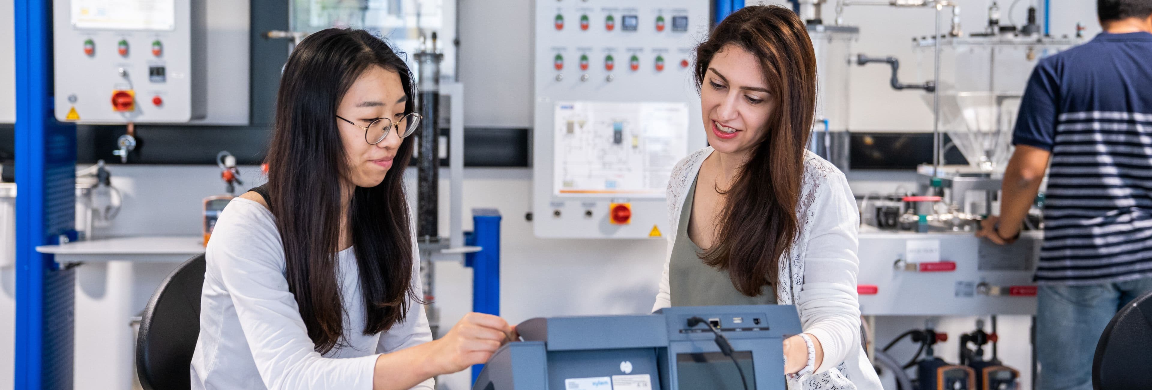 Two students working in an engineering lab.