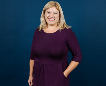 Amanda Willis in front of a navy blue background