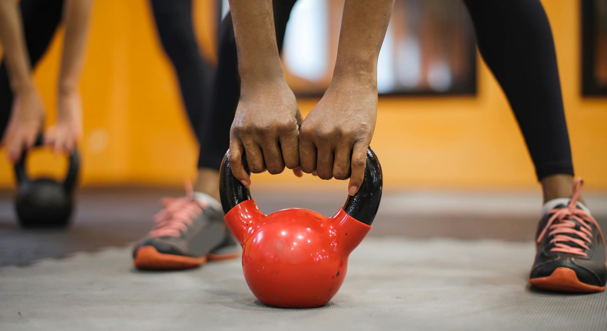 Woman's hands lifting dumbbell