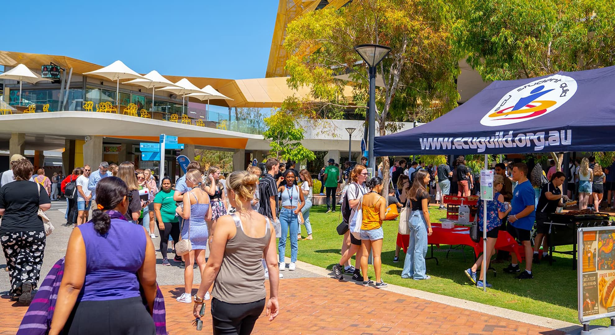 Large gathering of university students and staff at an on-campus event