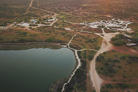 Overhead view of a town and a lake.