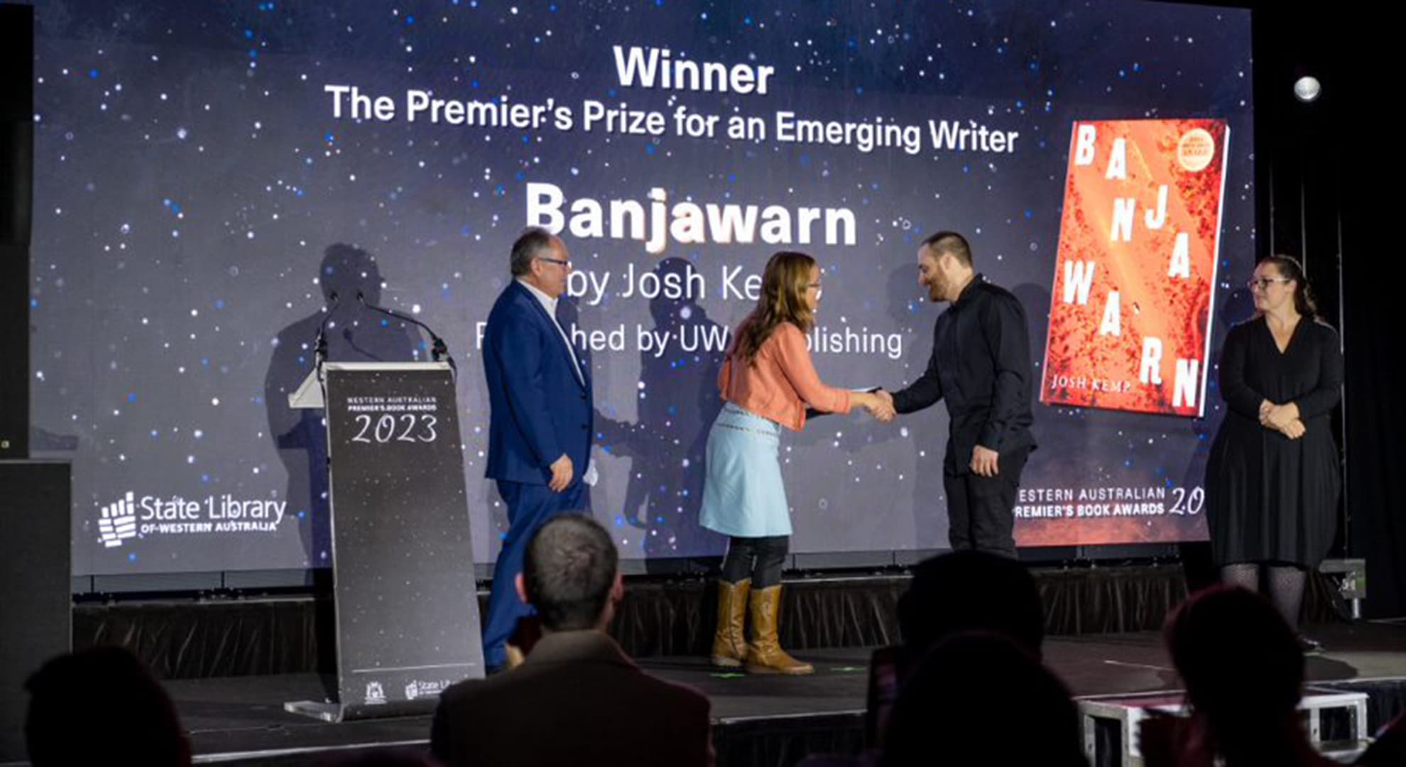 Dr Josh Kemp is presented with the Emerging Writer Award by Hon David Templeman and WA author Renee Pettitt-Schipp