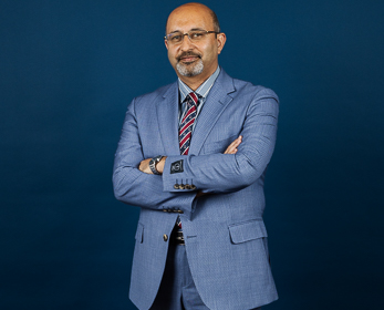 Professor Mostafa Rasoolimanesh in front of a navy blue background