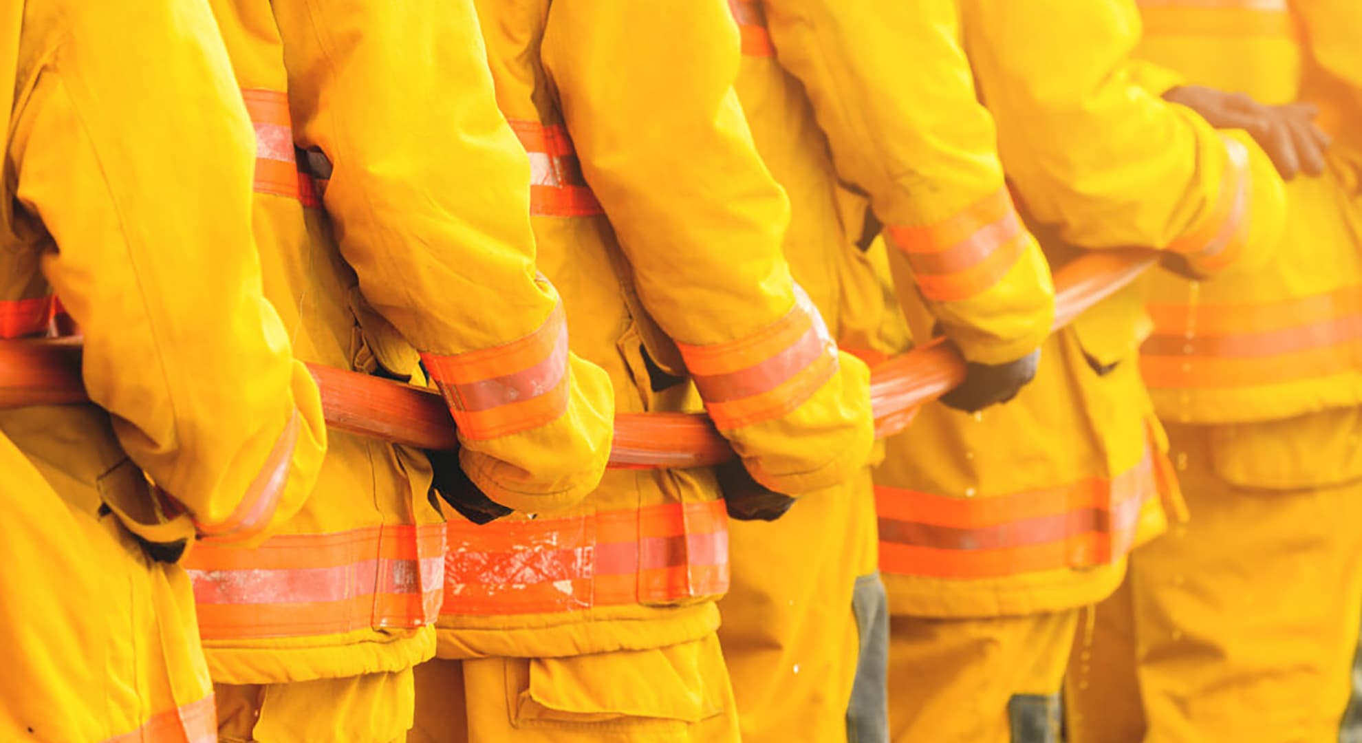 Firefighters holding fire hose.