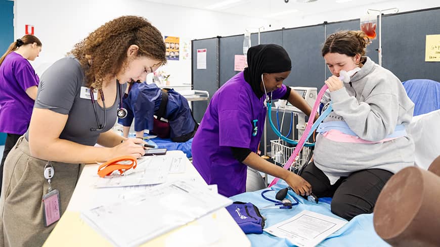 Three woman simulating a medical scenario