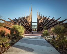 Students walk in front of building one as its tall spires reach for the sky.