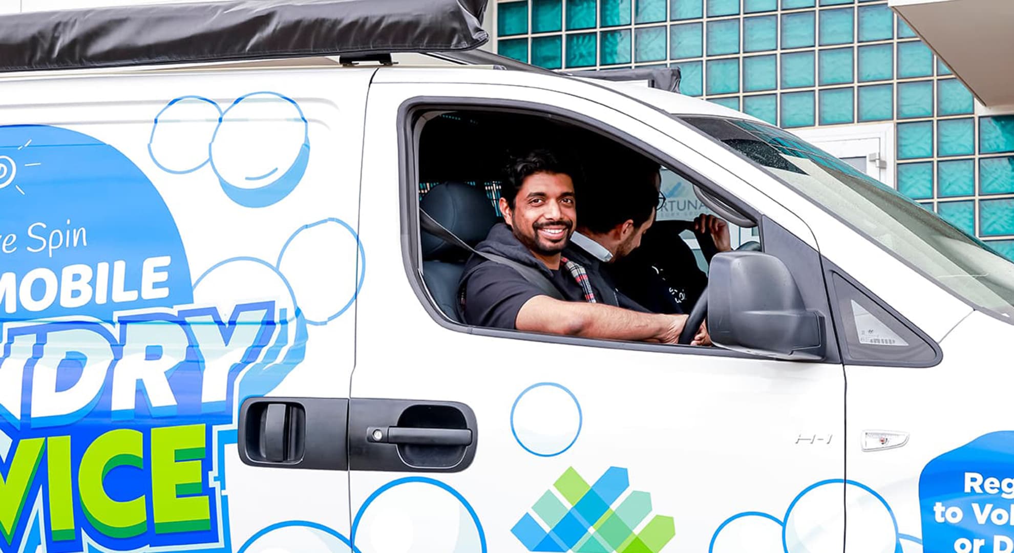 Man driving a van in the city of Perth.