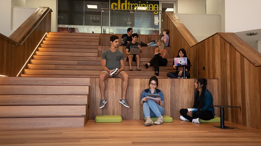 Male and female students meeting in a university library