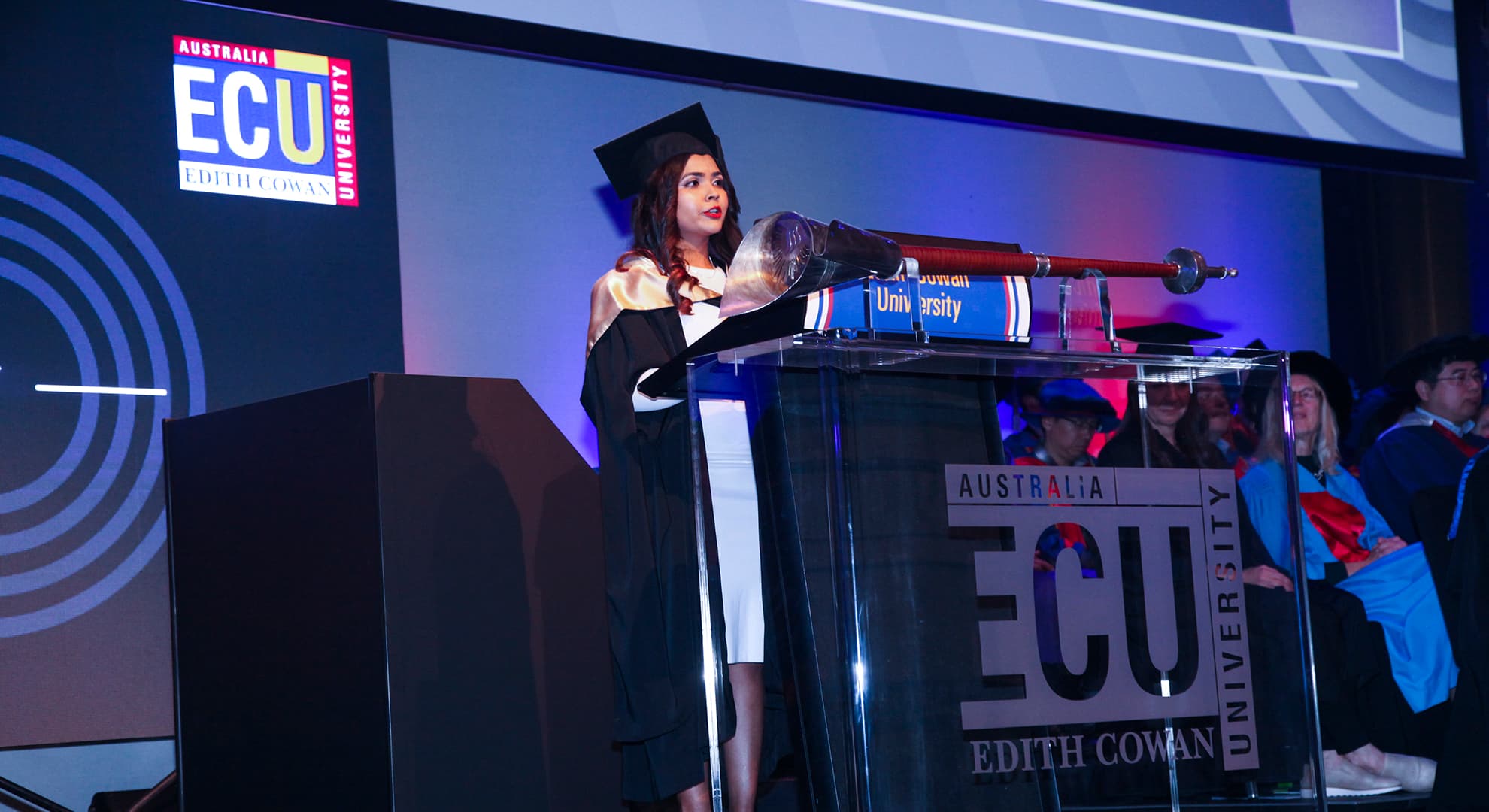 Maisha Zuhair speaking at the lectern ECU’s graduation for the School of Business and Law in September 2021.