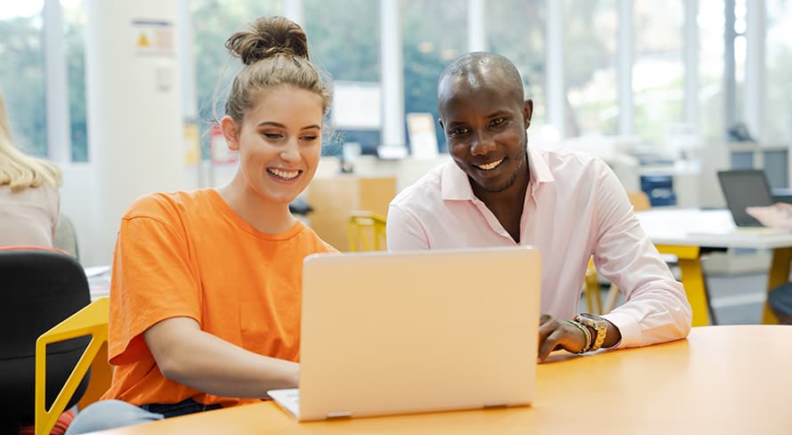 Two mature age ECU students working together at a laptop.