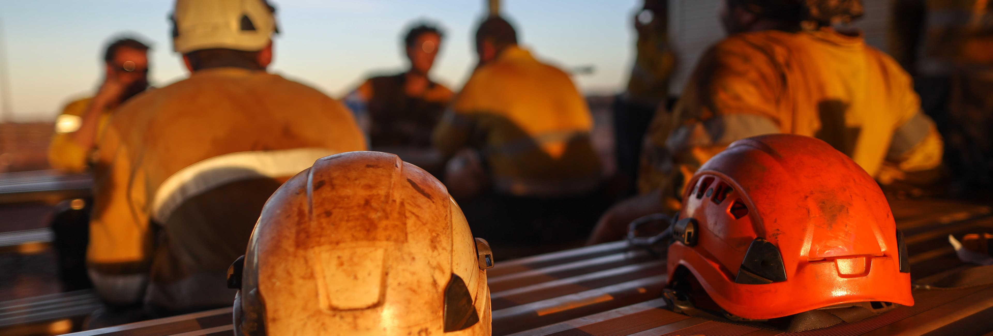 Rear view of two mine workers wearing hard hats