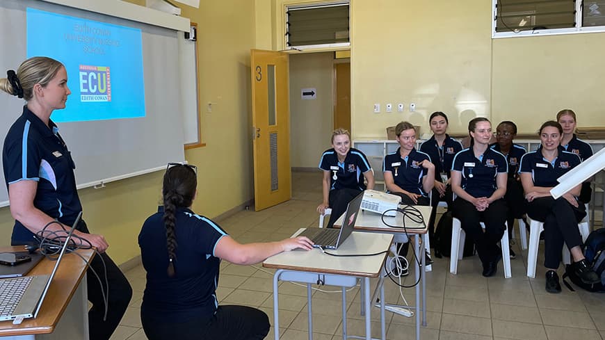 Students doing a presentation in a large room.