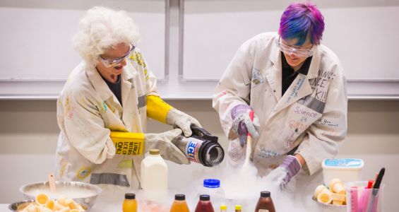 Two people conducting a science experiment demonstration.