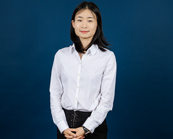 Dr Eden Li in front of a navy blue background