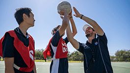 Secondary school students with a pre-service teacher playing sport