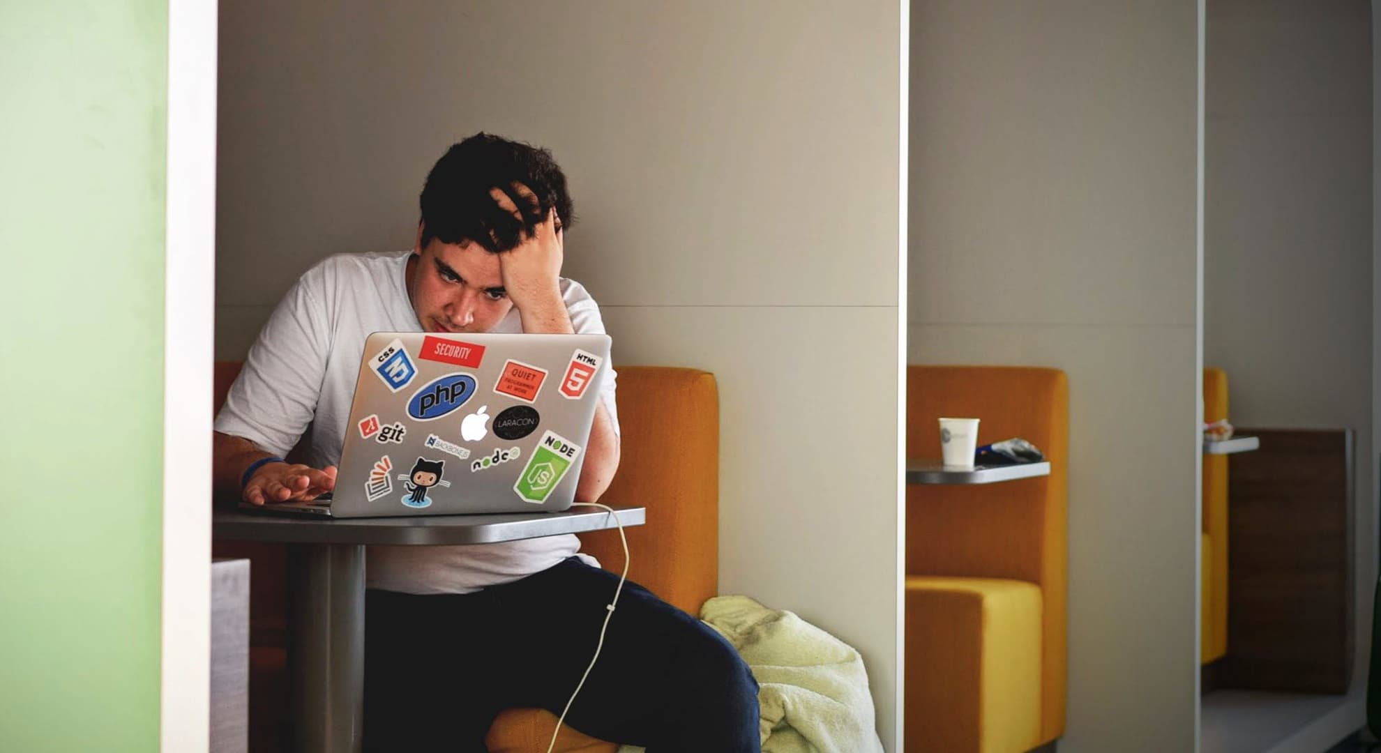 Sad person sitting with a laptop