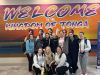 Students below 'Welcome to Tonga' sign