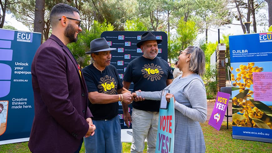 ECU staff shaking hands with speaks from the event and Professor Braden Hill