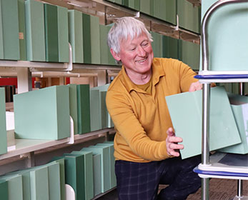 ECU Visual Arts lecturer and artist Gregory Pryor loads empty periodical boxes onto a trolley at Mount Lawley Library.