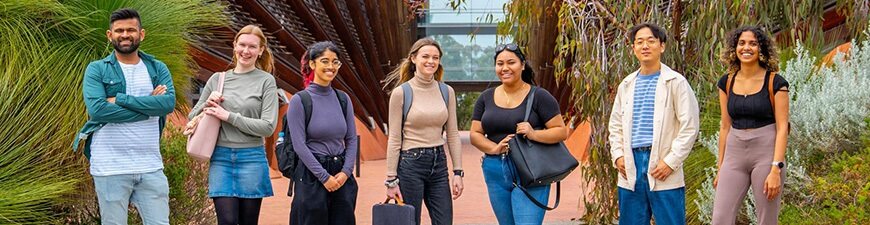 A group of students standing outside a university building