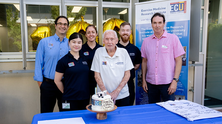 Kevin Ryan and the Vario Health Clinic team pose with the birthday cake.