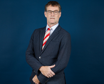 Dr Erwin Losekoot in front of a navy blue background