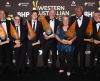 A group of individuals holding very big trophies.