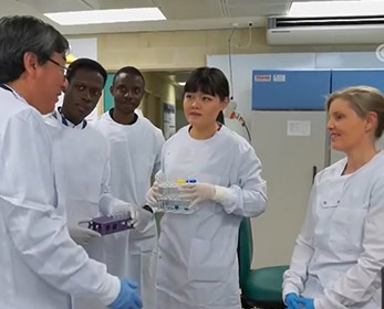 Professor Wei Wang with students in the lab.