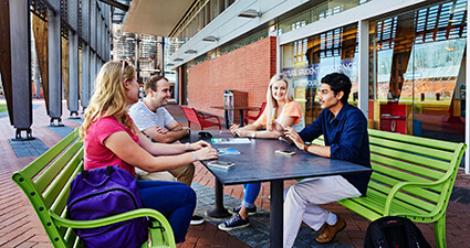 A group of students sitting around a table talking