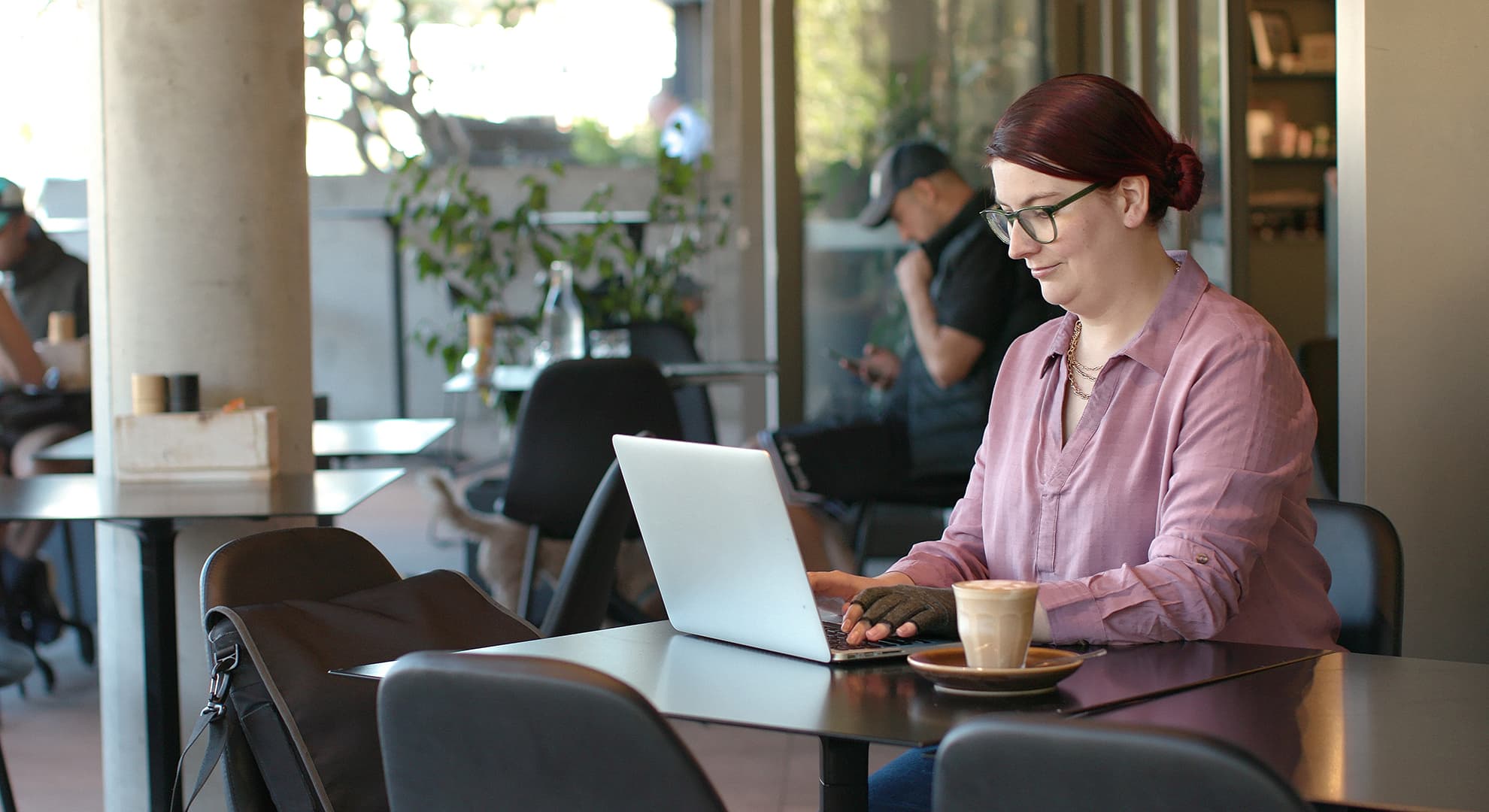 Woman sitting at a desk with a laptop computer.