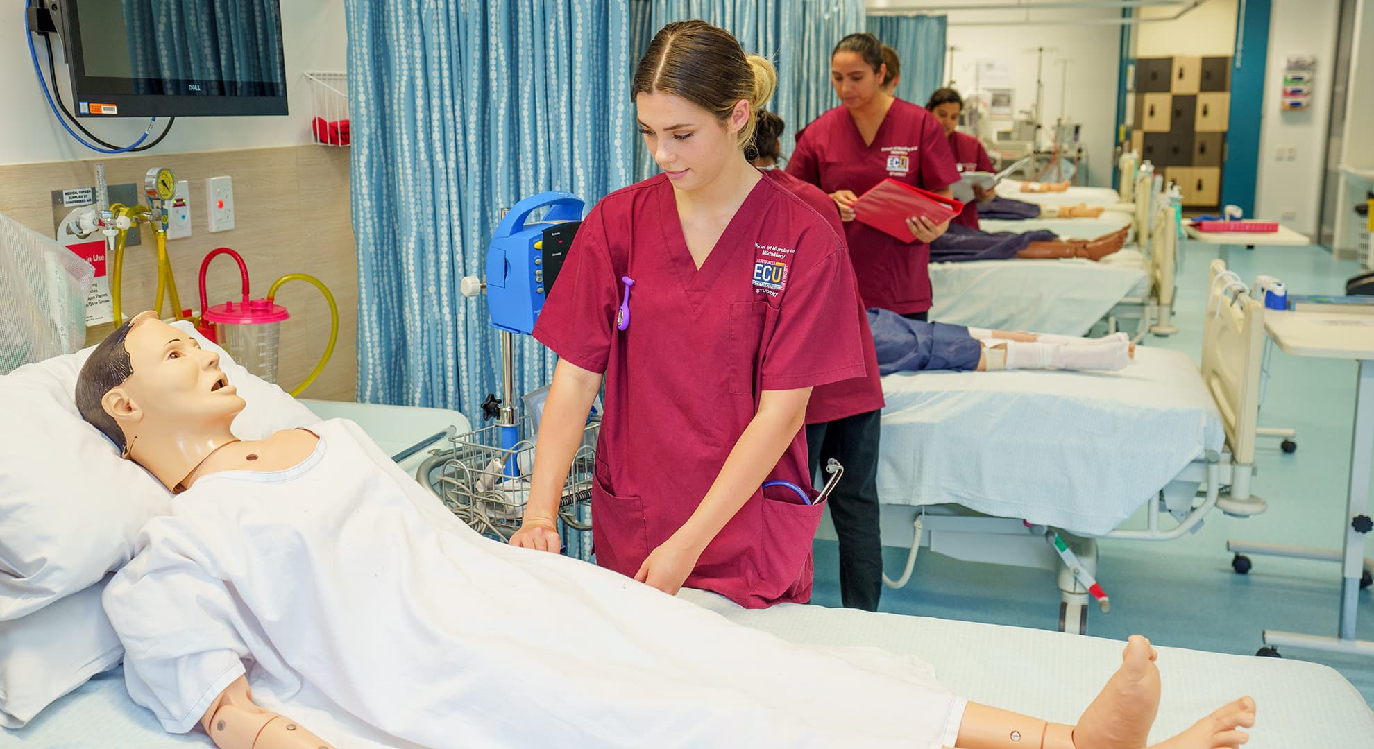 Nursing students attending to dummy patients