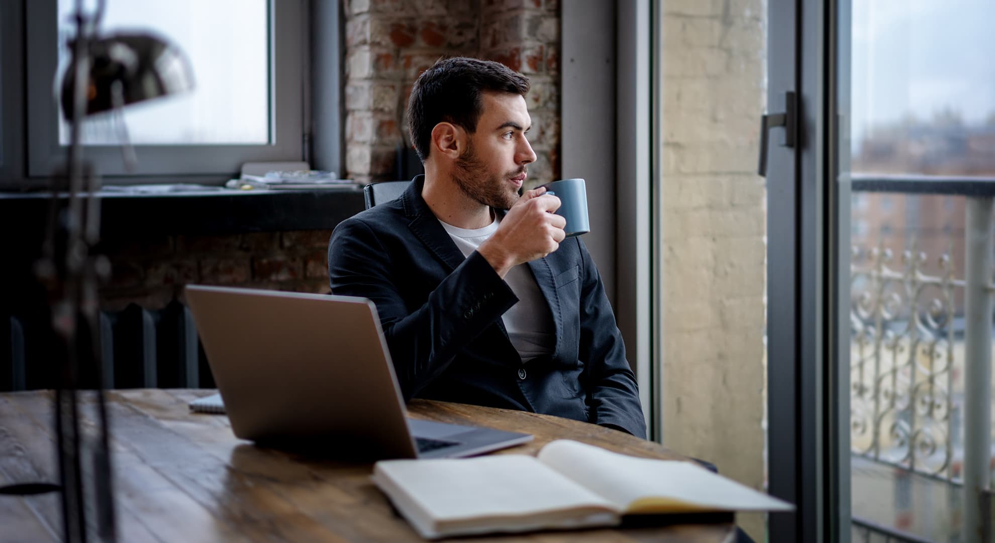 Man drinking coffee at a desk