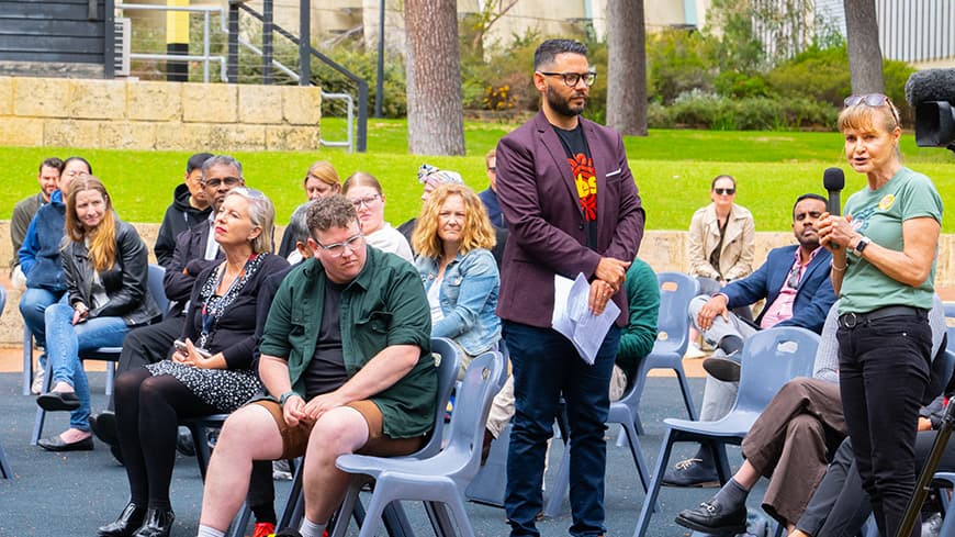 Audience member asks a question with Professor Braden Hill.