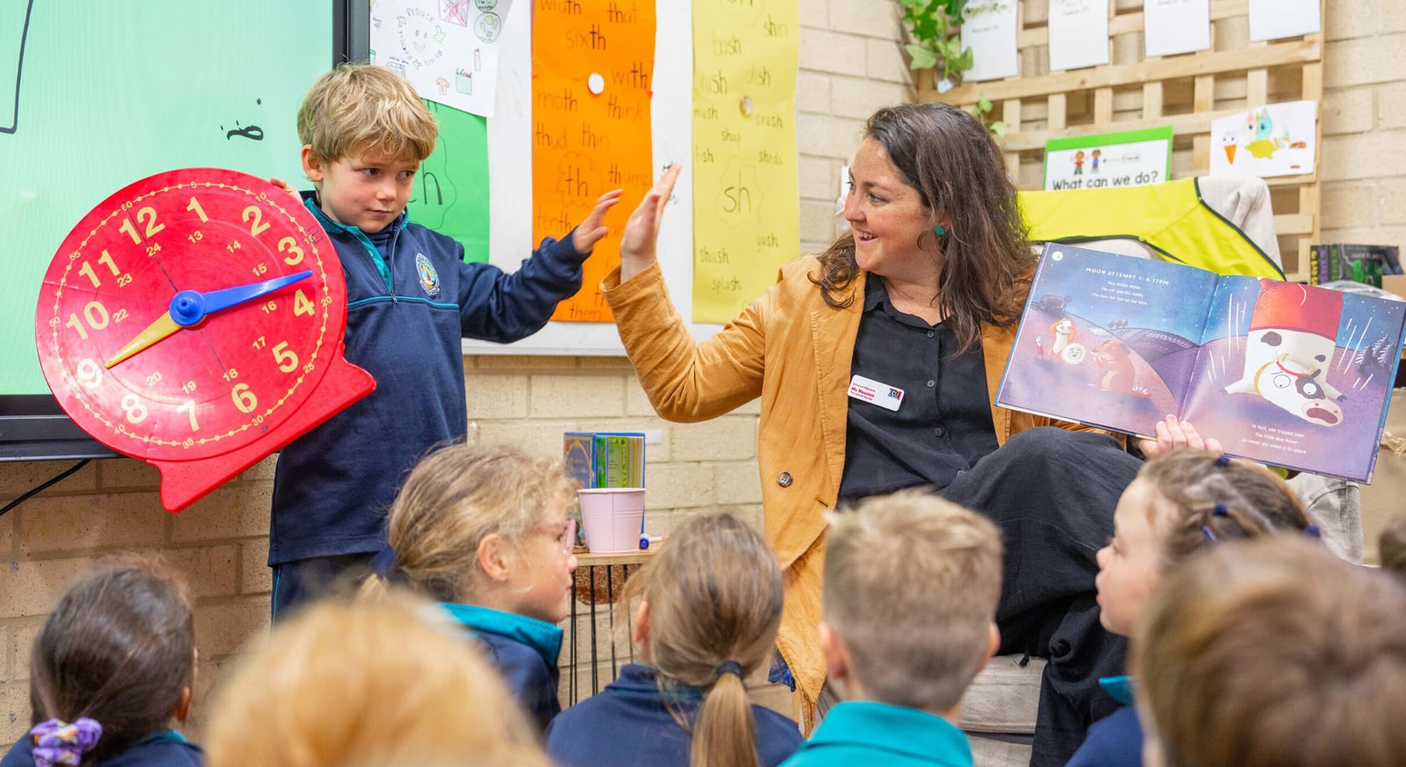 Trainee teacher in classroom with young students