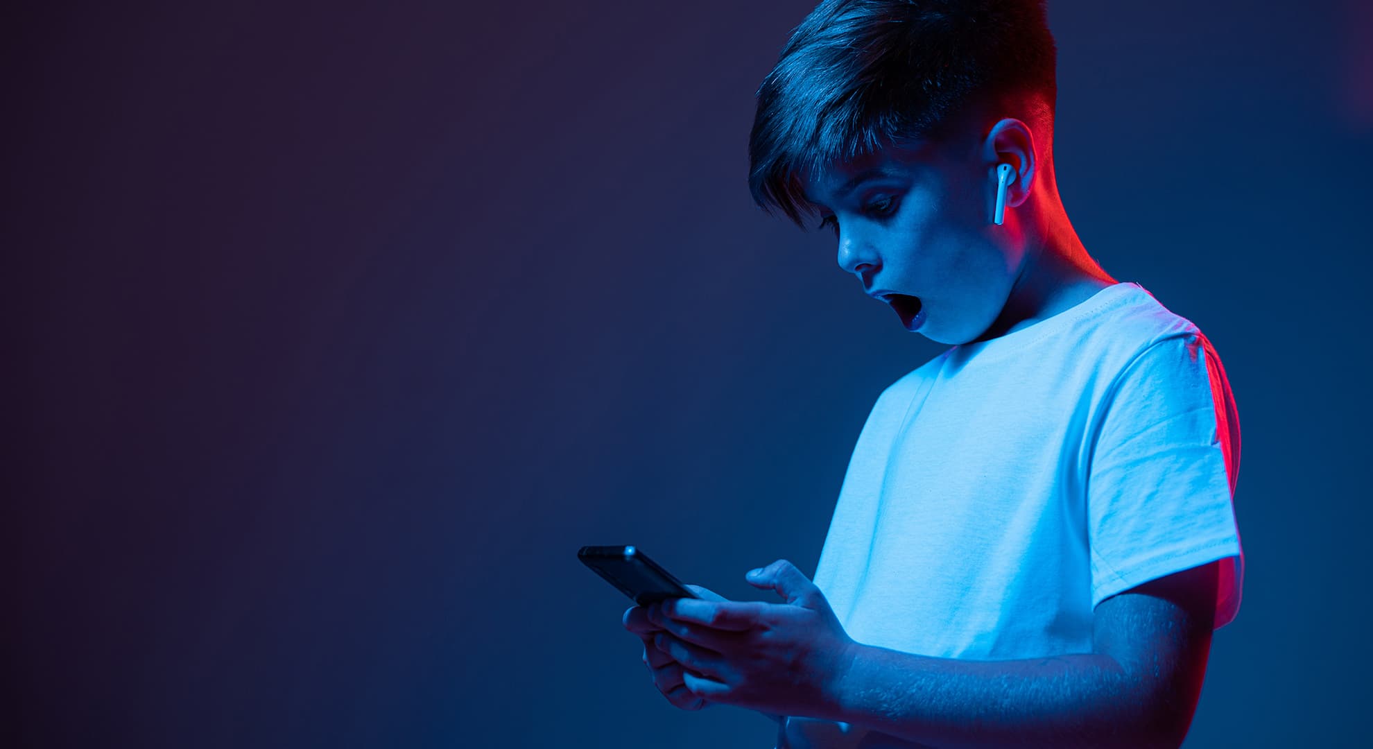 Young boy holding phone