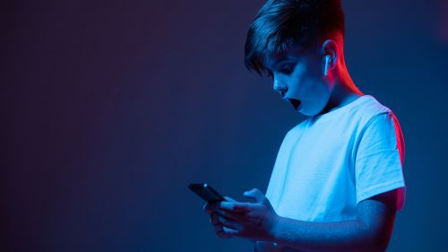 Young boy holding phone