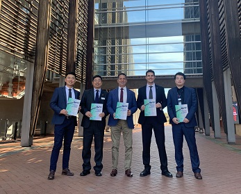 Five men in suits holding research report.