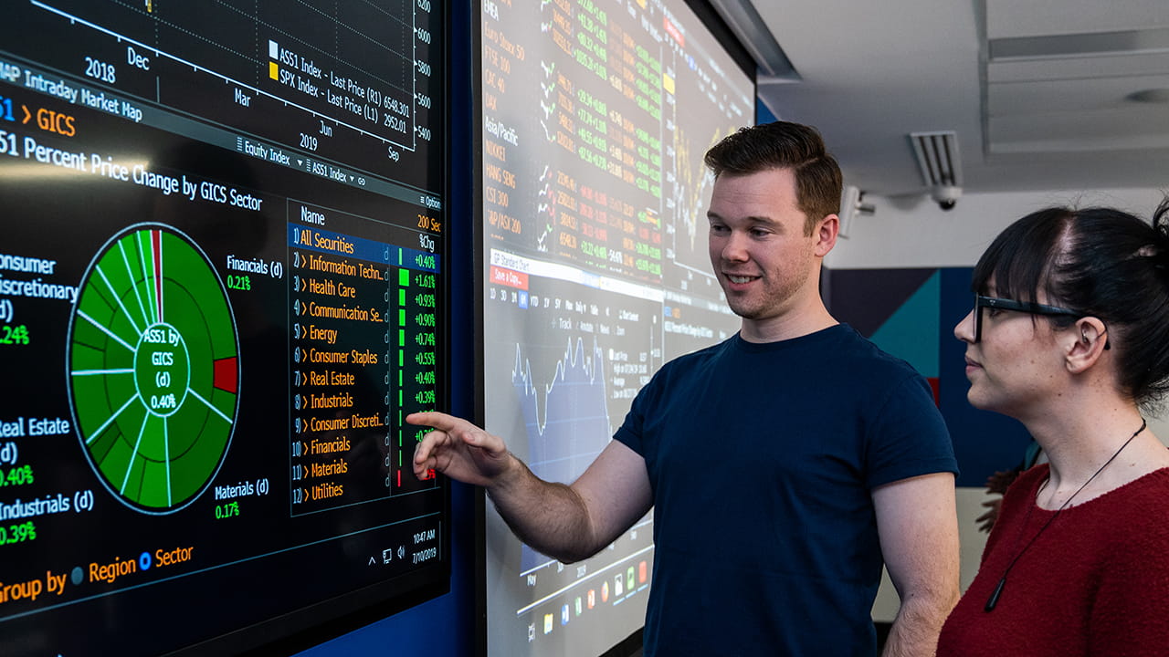 Students looking at a digital information panel