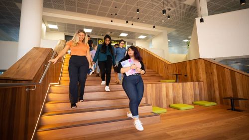 ECU students Lisa Wallman, Oshadi Wijetunga, Constance Green and Helia Moayedi on the new stairs in the ECU Library.