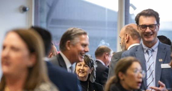 Business people wearing suits at a corporate function