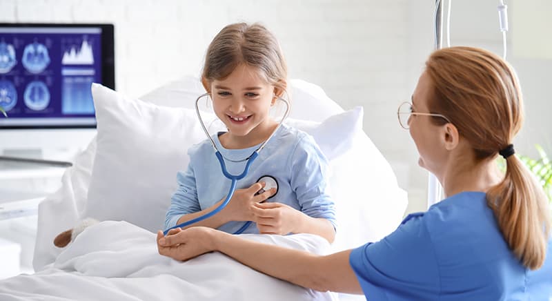 nurse listening to child's heartbeat with stethescope