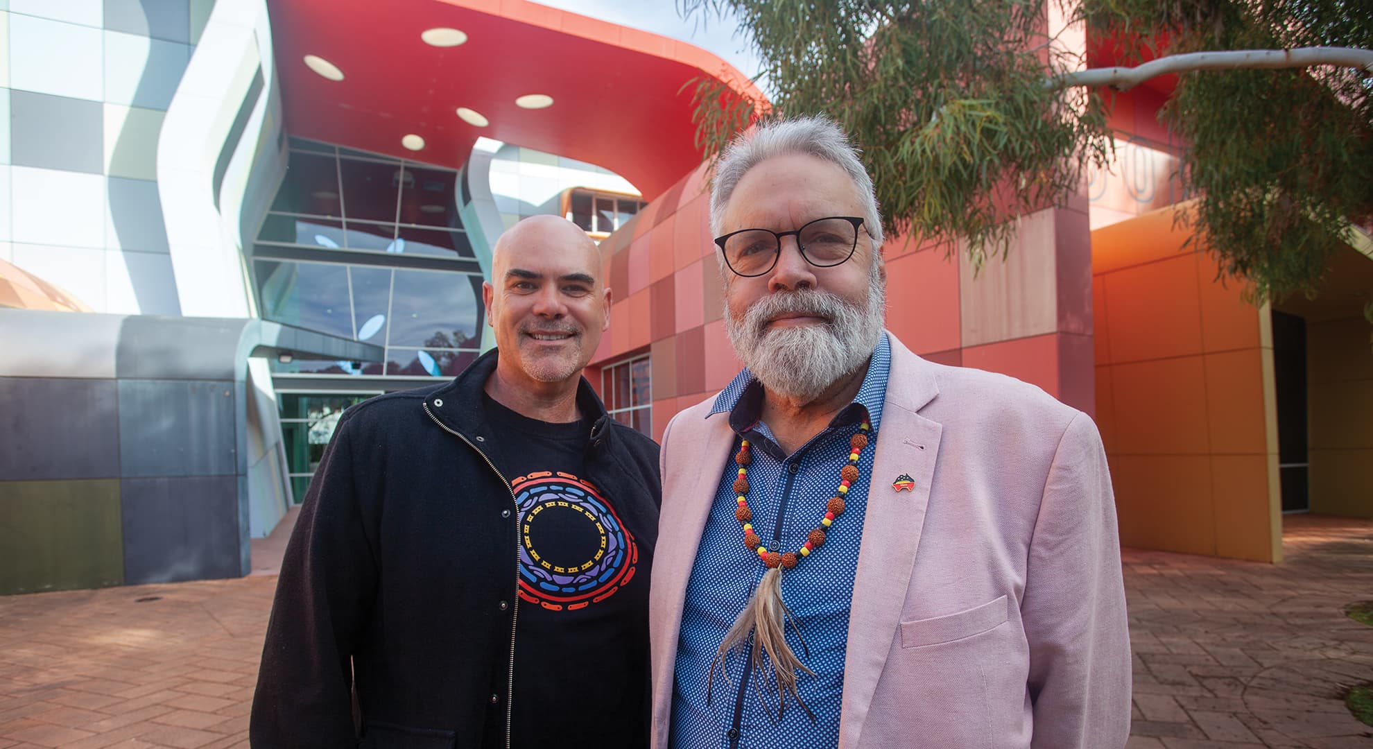 two men standing together in front of the Kurongkurl Katitjin building.